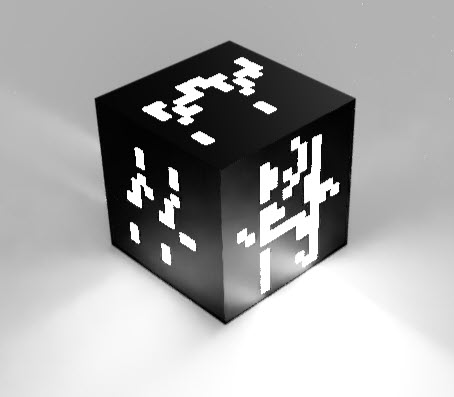 A black cube in which three faces are visible. The cube itself is black, but there are square and rectangular cutouts in the surface through which light is shining. The artwork that the rectangular features form does not immediately look figurative, but evokes imagination of what the art could represent.
